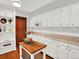 Spacious kitchen with white cabinetry, ample counter space, and built-in shelves at 1247 Dexter St, Denver, CO 80220