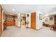 Spacious basement area with built-in shelves, carpet, and a partially-visible seating area at 266 Lodgepole Dr, Evergreen, CO 80439