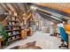 Bonus room with wood plank walls, desk, and built-in shelving for storage and display at 266 Lodgepole Dr, Evergreen, CO 80439