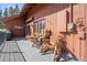 Inviting deck with rustic wooden furniture, perfect for outdoor relaxation at 266 Lodgepole Dr, Evergreen, CO 80439