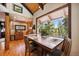 Bright dining area features wood floors, large picture window, and vaulted wood ceiling at 266 Lodgepole Dr, Evergreen, CO 80439