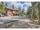 Exterior showcasing the home's design with a hot tub, balconies, and wooded surroundings at 266 Lodgepole Dr, Evergreen, CO 80439
