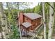 Exterior view of the home surrounded by lush trees, highlighting its natural setting at 266 Lodgepole Dr, Evergreen, CO 80439