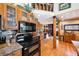 Kitchen showcasing wooden cabinets, modern appliances, granite countertops, and a view of the home's interior at 266 Lodgepole Dr, Evergreen, CO 80439