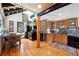 Cozy kitchen with wooden cabinets, modern appliances, a breakfast nook, and a decorative stone accent wall at 266 Lodgepole Dr, Evergreen, CO 80439