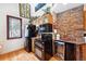 Kitchen area featuring black appliances, wooden cabinets, stone accents, and an adjacent dining area with natural light at 266 Lodgepole Dr, Evergreen, CO 80439