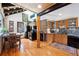 Charming kitchen with wood cabinets, stone accent wall, and hardwood floors, creating a cozy and functional space at 266 Lodgepole Dr, Evergreen, CO 80439