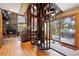 Open living room with unique spiral staircase and fireplace near a sliding door to the deck at 266 Lodgepole Dr, Evergreen, CO 80439