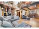 Spacious living room features wood beams, hardwood floors, comfortable gray sectional couch, and unique decor at 266 Lodgepole Dr, Evergreen, CO 80439