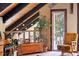 Cozy living room with wood beamed ceilings, a large window, and comfortable seating at 266 Lodgepole Dr, Evergreen, CO 80439
