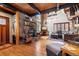 Inviting living room featuring a stone fireplace, wood floors, and comfortable seating at 266 Lodgepole Dr, Evergreen, CO 80439