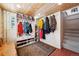 Inviting mudroom features custom built-ins for storage, a wood plank ceiling, and decorative rug on tile flooring at 266 Lodgepole Dr, Evergreen, CO 80439