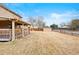 Large, fenced backyard with a covered porch, grass, and a storage shed at 8610 E Eastman Ave, Denver, CO 80231