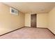 View of the basement with carpet flooring, access to a small crawl space, and neutral-colored walls at 8610 E Eastman Ave, Denver, CO 80231