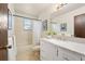 Bathroom featuring tiled floor, updated vanity with drawers, and a shower-tub combination at 8610 E Eastman Ave, Denver, CO 80231