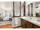 Bathroom featuring decorative partitions, mirror, vanity and sink, all adjacent to the bedroom at 8610 E Eastman Ave, Denver, CO 80231