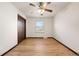 Bedroom with hardwood floors, a ceiling fan, and a window with natural light at 8610 E Eastman Ave, Denver, CO 80231