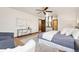 Bright bedroom featuring a ceiling fan, hardwood floors, and contemporary decor at 8610 E Eastman Ave, Denver, CO 80231