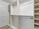 Walk-in closet with custom shelving, rods, and ample storage space at 8610 E Eastman Ave, Denver, CO 80231