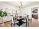 Elegant dining room with modern lighting, a dark wood table, and hardwood floors at 8610 E Eastman Ave, Denver, CO 80231