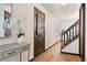 A hallway with a wooden door and staircase at 8610 E Eastman Ave, Denver, CO 80231