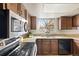 The kitchen has granite countertops and stainless steel appliances at 8610 E Eastman Ave, Denver, CO 80231