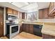 The kitchen has stainless steel appliances and granite countertops at 8610 E Eastman Ave, Denver, CO 80231