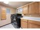 Laundry room with a front-load washer and dryer, cabinets, and countertop space at 8610 E Eastman Ave, Denver, CO 80231