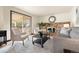 Inviting living room featuring a brick fireplace, stylish decor, and sliding door access to the outdoor patio at 8610 E Eastman Ave, Denver, CO 80231