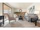 Cozy living room with a brick fireplace, comfortable seating, and a sliding door to the patio at 8610 E Eastman Ave, Denver, CO 80231