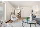 Open-concept living room featuring hardwood floors, a patterned rug, and a staircase to the upper level at 8610 E Eastman Ave, Denver, CO 80231