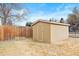 Backyard storage shed with a neutral color, offering ample storage space at 8610 E Eastman Ave, Denver, CO 80231