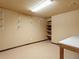 Basement storage area features built-in shelving and an open workbench area at 8610 E Eastman Ave, Denver, CO 80231