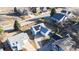 Aerial view of a blue home featuring an attached garage, a driveway, and modern solar panels at 1265 Iris Ct, Highlands Ranch, CO 80126