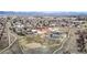 Aerial view showcases community with school, playground, and stunning mountain views at 1265 Iris Ct, Highlands Ranch, CO 80126