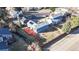 Aerial shot of a landscaped backyard with a large red stained wooden deck and fenced yard at 1265 Iris Ct, Highlands Ranch, CO 80126