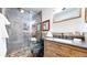 Modern bathroom features a stylish vanity, stone tiles, and a walk-in shower at 1265 Iris Ct, Highlands Ranch, CO 80126