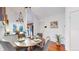 Charming dining area with seating for four and modern lighting fixtures at 1265 Iris Ct, Highlands Ranch, CO 80126