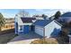 Stunning blue home boasts a two-car garage and modern solar panels on the roof at 1265 Iris Ct, Highlands Ranch, CO 80126