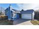 Striking blue home with a well-maintained lawn and solar panels adorning the roof at 1265 Iris Ct, Highlands Ranch, CO 80126