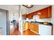 Open concept kitchen with stainless steel appliances, wood cabinets, and hardwood floors at 1265 Iris Ct, Highlands Ranch, CO 80126