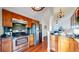 Well-equipped kitchen features stainless steel appliances, wood cabinets, and granite counters at 1265 Iris Ct, Highlands Ranch, CO 80126
