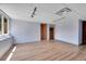 Large basement area with track lighting and two doors at 3145 S Bryant St, Englewood, CO 80110