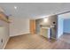 Unfinished basement area with laminate floors and a utility sink at 3145 S Bryant St, Englewood, CO 80110