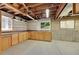 Unfinished basement featuring exposed ceiling, shelves, and built-in cabinets at 3145 S Bryant St, Englewood, CO 80110