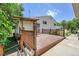 Side view of a wood deck with wood railings, and an entrance to the house at 3145 S Bryant St, Englewood, CO 80110