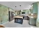 Modern kitchen featuring an island, stainless steel appliances, elegant pendant lighting, and tile backsplash at 3145 S Bryant St, Englewood, CO 80110