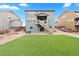 Beautiful backyard featuring a well-maintained lawn, deck, and patio area for outdoor entertainment at 17949 W 94Th Dr, Arvada, CO 80007