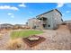 Landscaped backyard with artificial turf, rock features, and a wooden playset at 17949 W 94Th Dr, Arvada, CO 80007