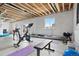 Unfinished basement with exposed ceiling, bright window, and potential for a home gym at 17949 W 94Th Dr, Arvada, CO 80007